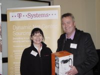 Ms Elizabeth Roman (T-Systems SA) handing over the prize to the lucky draw winner, Mr Peet Cronje (4-Africa (Pty)Ltd) sponsored by T-Systems SA (Pty)Ltd