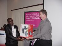 Mr Peter Filbey (T-Systems) handing over the prize to the lucky draw winner, Mr Julius Kaipiti (DHL)