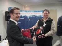Mr Rory Young (T-Systems SA (Pty)Ltd) handing over the prize to the lucky draw winner, Mr Albertus de Lange (DiBENE SOLUTIONS), proudly sponsored by T-Systems SA (Pty)Ltd
