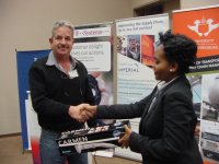 Ms Lilo Mkhwanazi (SizweNtsalubaGobodo) handing over the prize to the lucky draw winner, Mr Danny Sheftel (Interloc Freight Services), proudly sponsored by T-Systems SA(Pty)Ltd